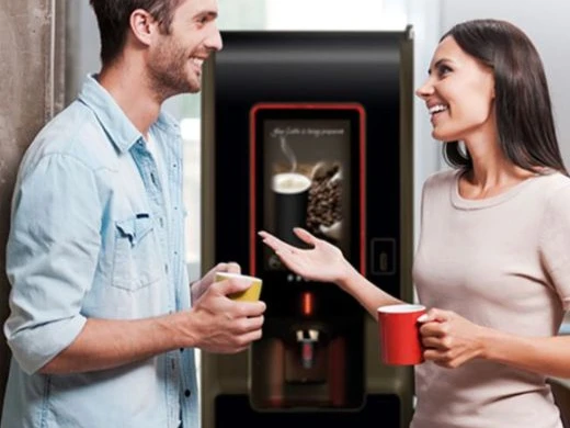 freestanding office coffee machine with people enjoying a hot beverage